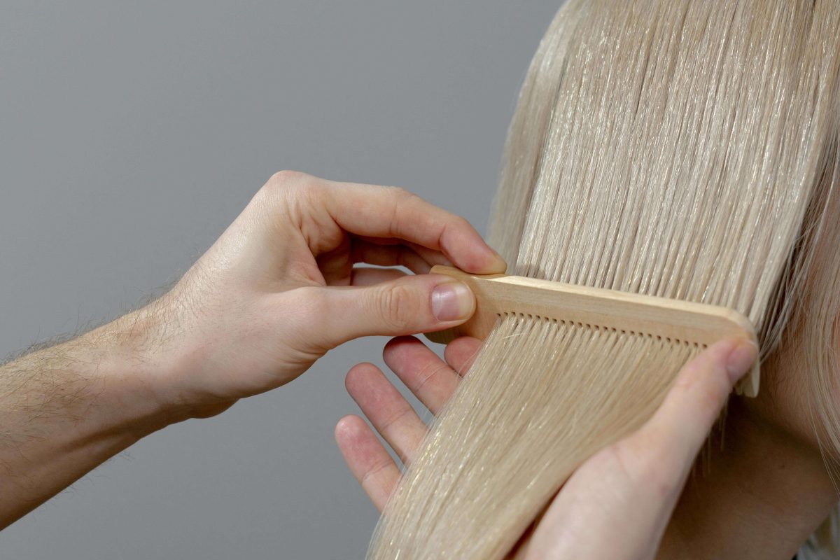 close up of smooth, shiny blonde strands showing healthy hair after bleaching